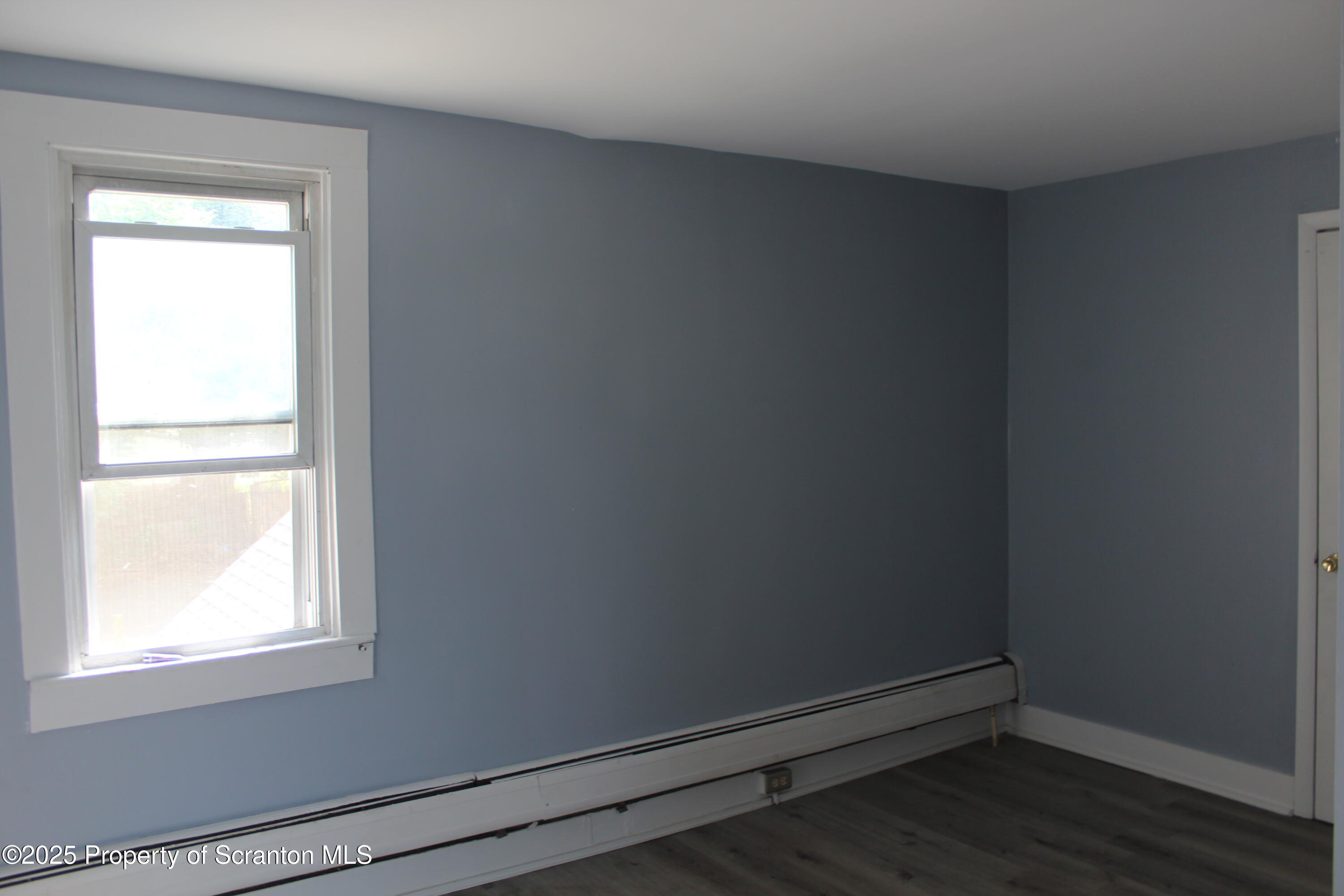 1507 Luzerne Street Scranton, PA 18504 - Photo 15 of 26 an empty room with wooden floor and windows