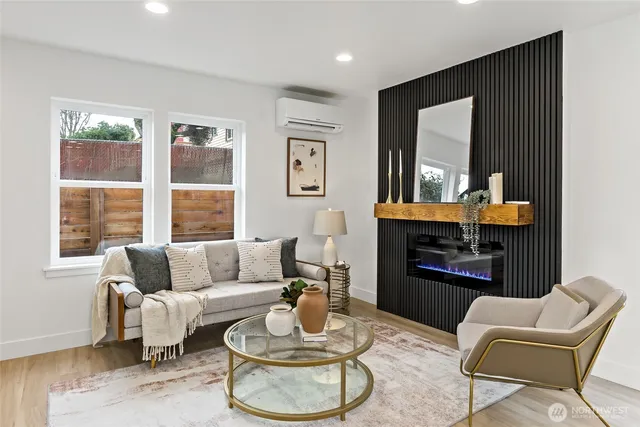a living room with fireplace furniture and a window
