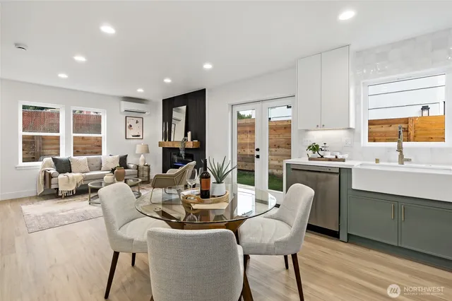 a dining room with furniture a window and wooden floor
