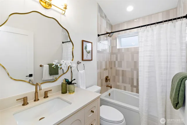 a bathroom with a sink a toilet and a bathtub