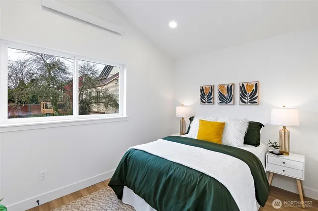 a bedroom with a bed and a large window