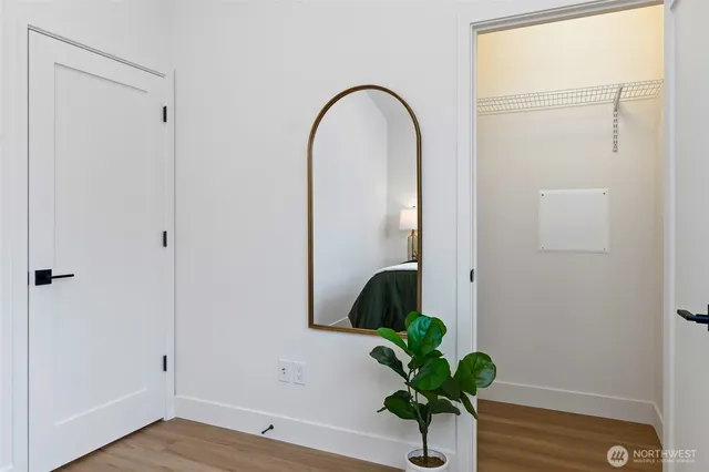 a view of a small space with potted plant and wooden floor