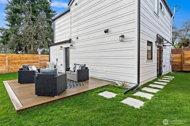 a view of a patio with couches chairs and a yard