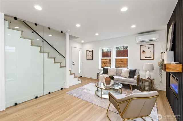 a living room with furniture and a wooden floor