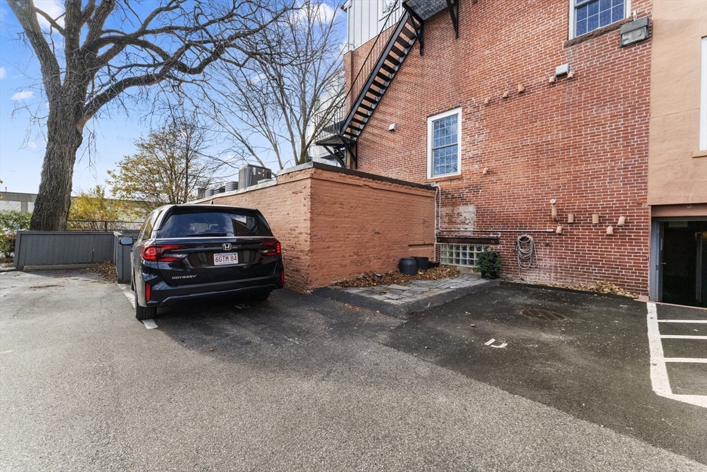 8 Newcomb Street, Unit 4 Boston, MA 02118 - Photo 15 of 16 a car parked in front of a brick house