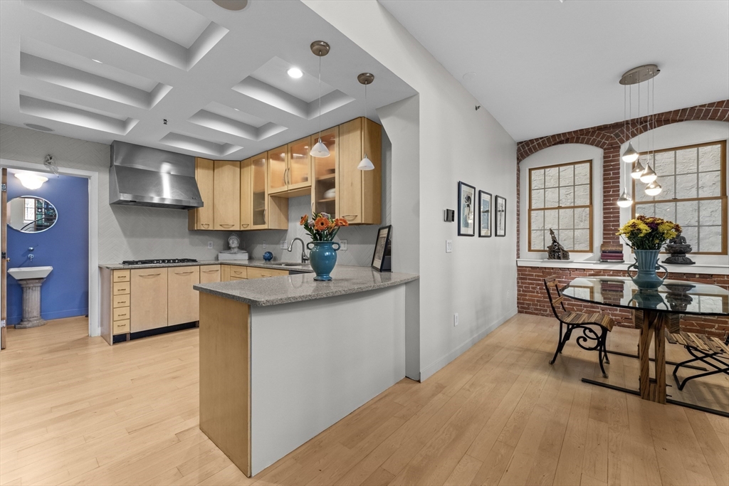 8 Newcomb Street, Unit 4 Boston, MA 02118 - Photo 8 of 16 a kitchen with white cabinets and outdoor space