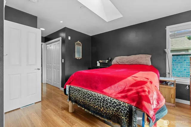 a bedroom with a bed and a potted plant