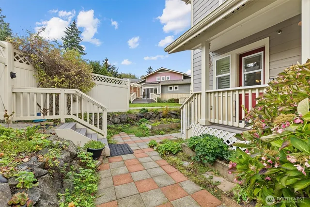 a view of a house with a small yard and flower plants