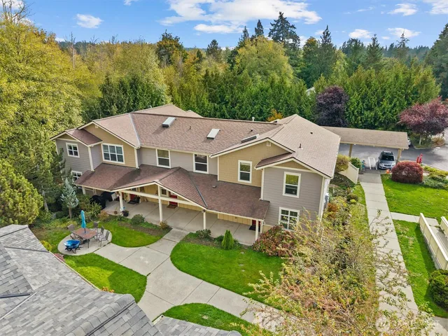 an aerial view of a house with a big yard