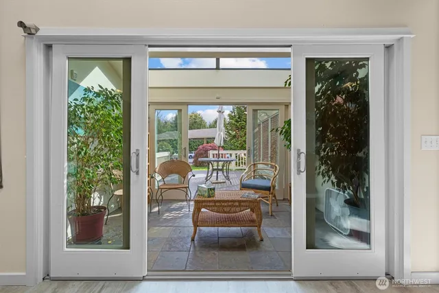a living room with furniture and a book shelf