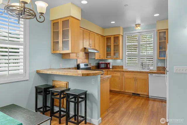 a kitchen with a sink cabinets and window