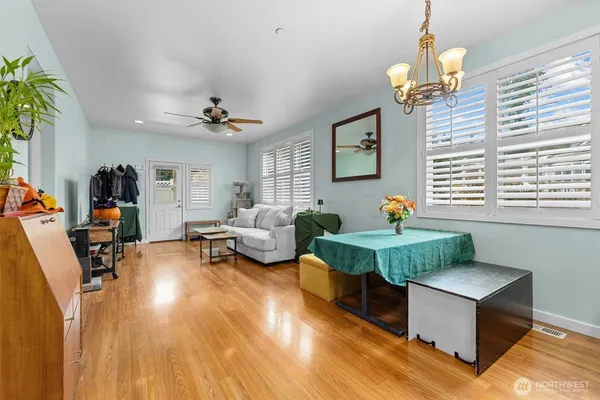 a living room with furniture a chandelier and a window