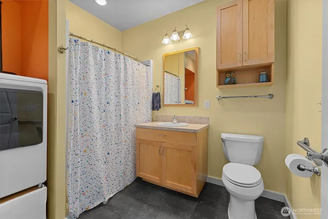 a bathroom with a toilet sink and a shower