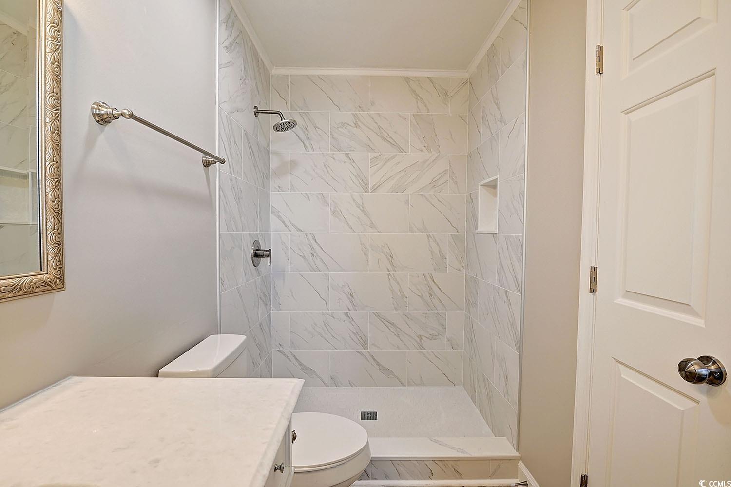 9450 Old Palmetto Road Murrells Inlet, SC 29576 - Photo 24 of 25 Bathroom with vanity, toilet, and tiled shower