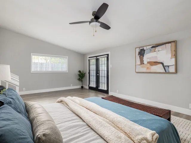 a bedroom with a bed and a chandelier