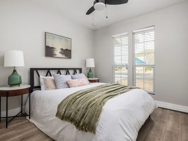 a bedroom with a bed and wooden floor