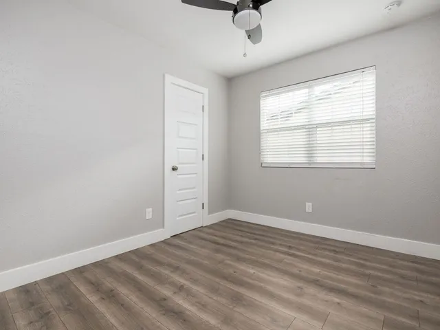 wooden floor in an empty room with a window