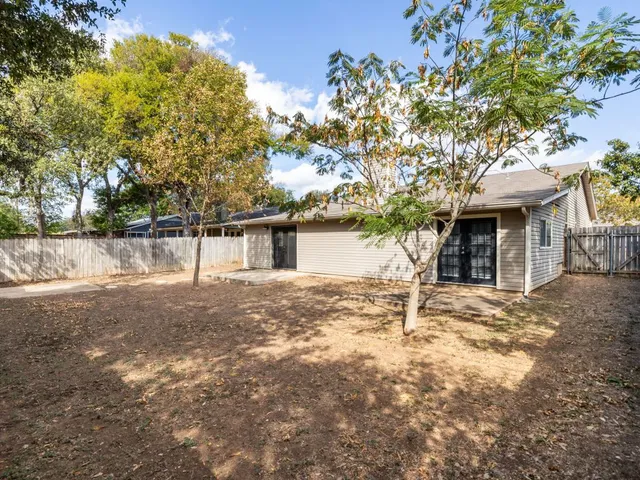 a front view of a house with a tree