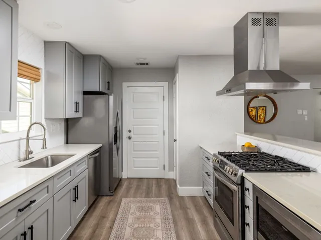 a kitchen with a stove and a sink
