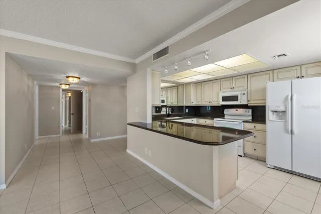 a kitchen with a sink and white cabinets