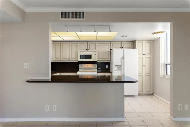 a kitchen with stainless steel appliances a refrigerator and a stove