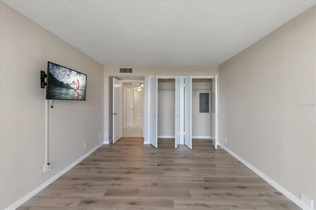 a view of empty room with wooden floor