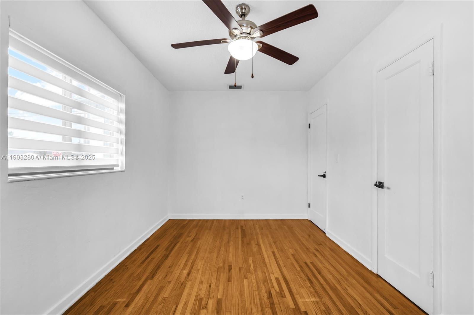 175 West 56th Street Hialeah, FL 33012 - Photo 12 of 39 a view of a room with wooden floor and a ceiling fan
