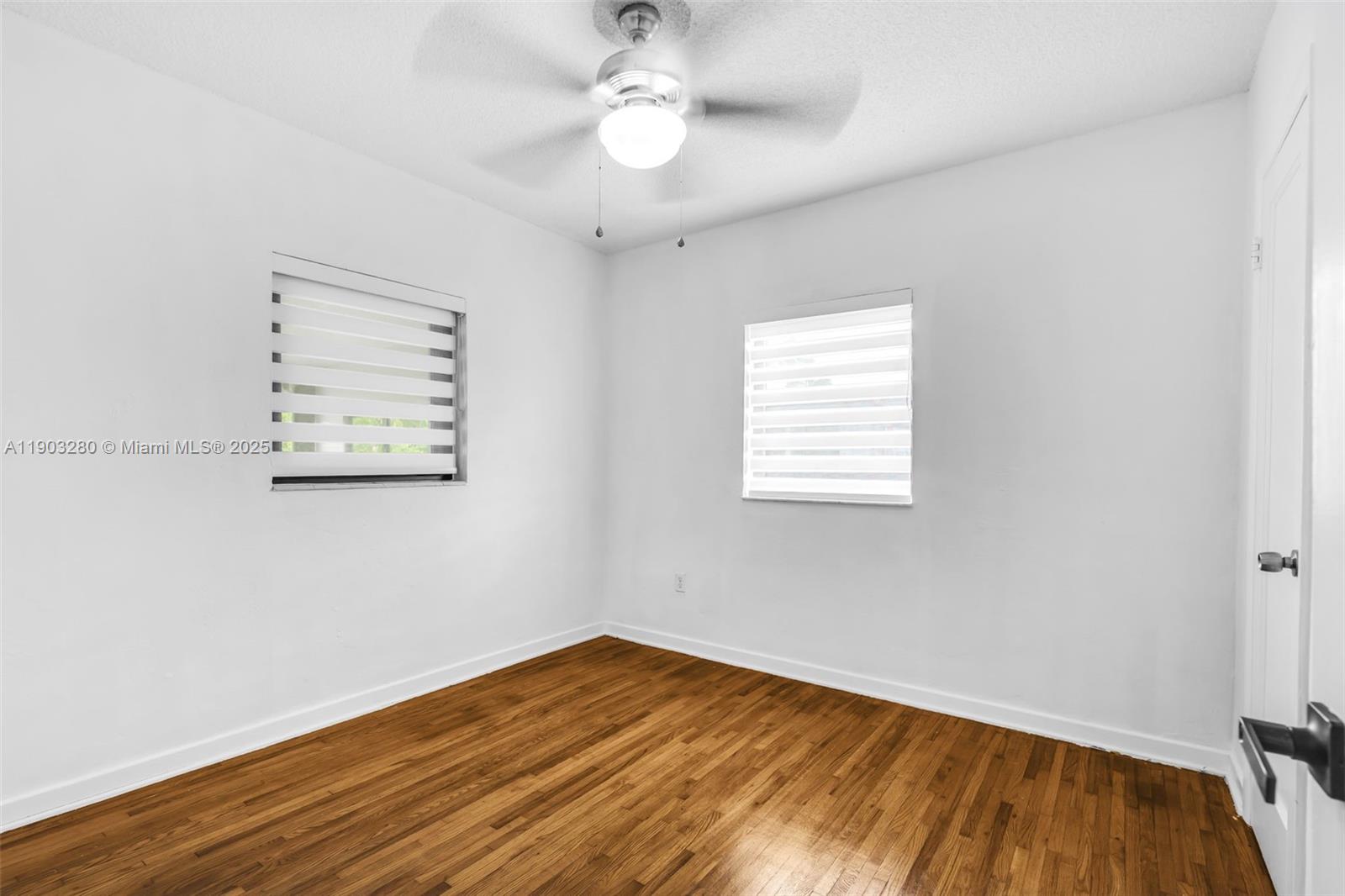 175 West 56th Street Hialeah, FL 33012 - Photo 13 of 39 wooden floor in an empty room with a window