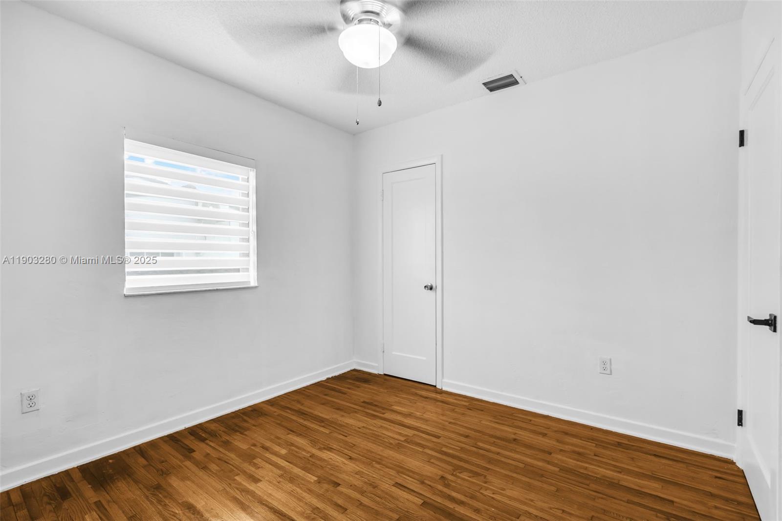 175 West 56th Street Hialeah, FL 33012 - Photo 14 of 39 wooden floor in an empty room with a window