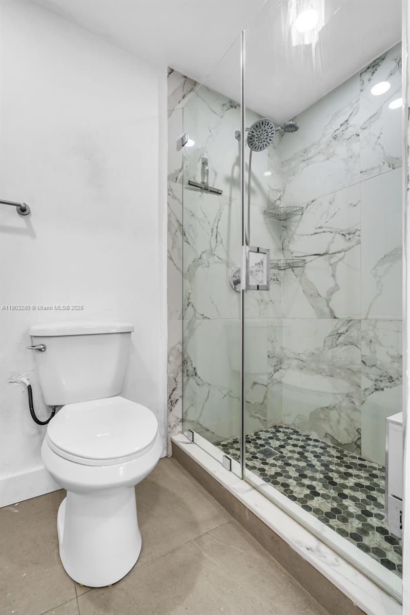 175 West 56th Street Hialeah, FL 33012 - Photo 22 of 39 a bathroom with a toilet and a shower