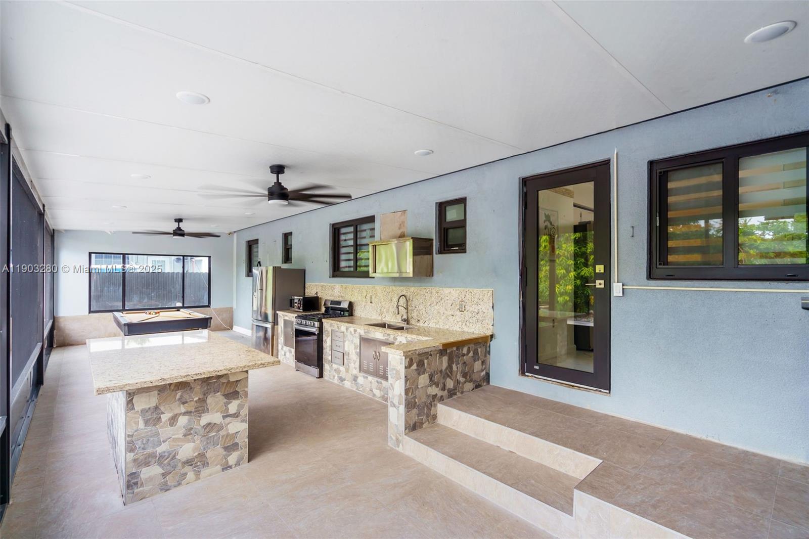 175 West 56th Street Hialeah, FL 33012 - Photo 23 of 39 a living room with furniture and large windows