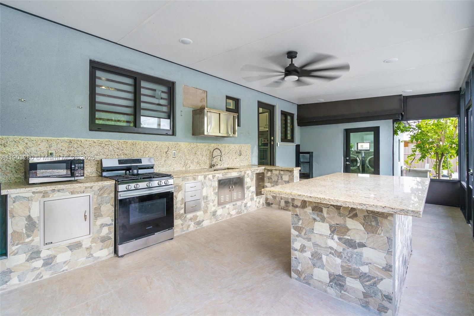 175 West 56th Street Hialeah, FL 33012 - Photo 25 of 39 a kitchen with stainless steel appliances granite countertop a stove and a sink