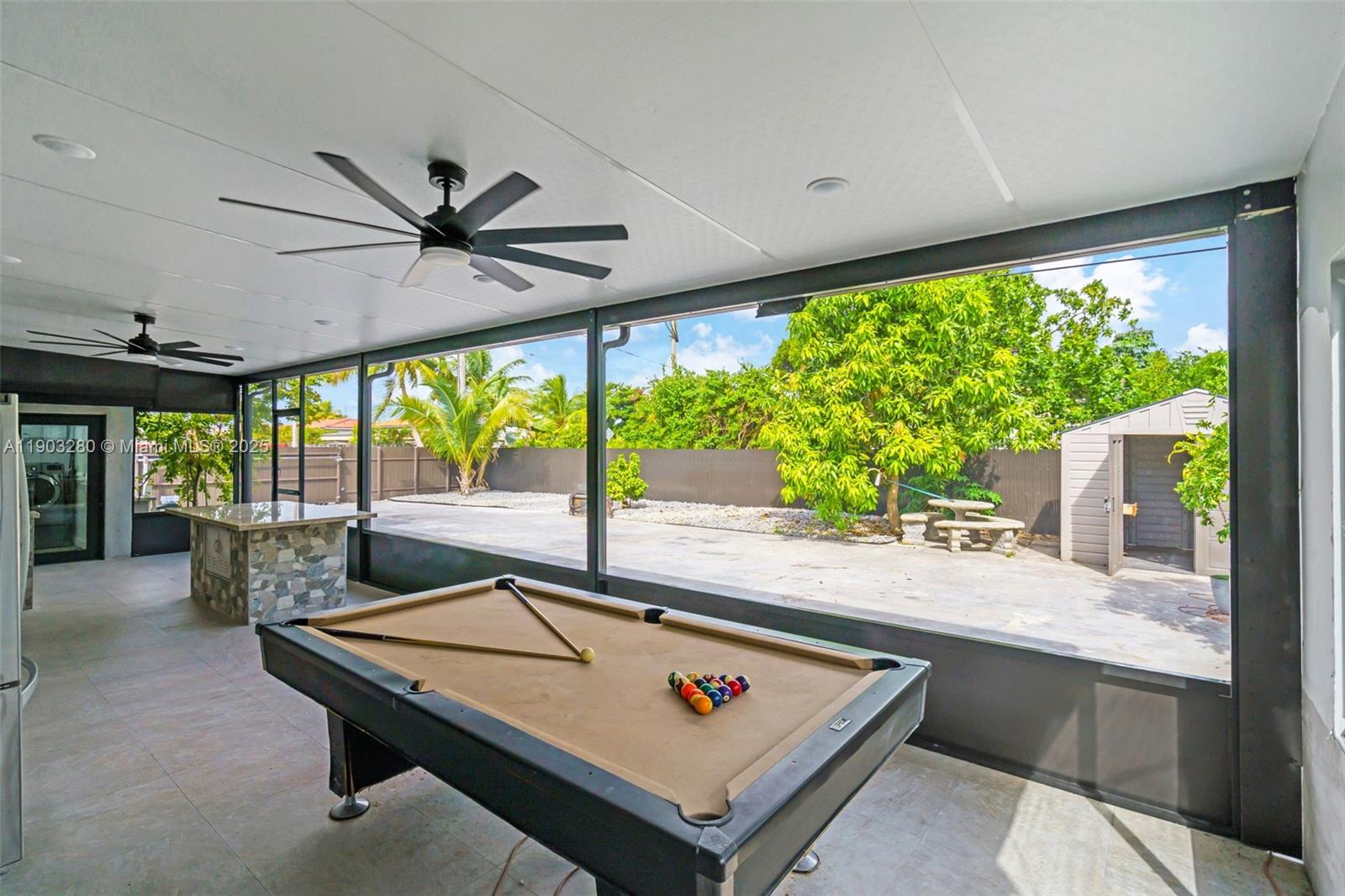 175 West 56th Street Hialeah, FL 33012 - Photo 27 of 39 a living room with pool table furniture and a large window