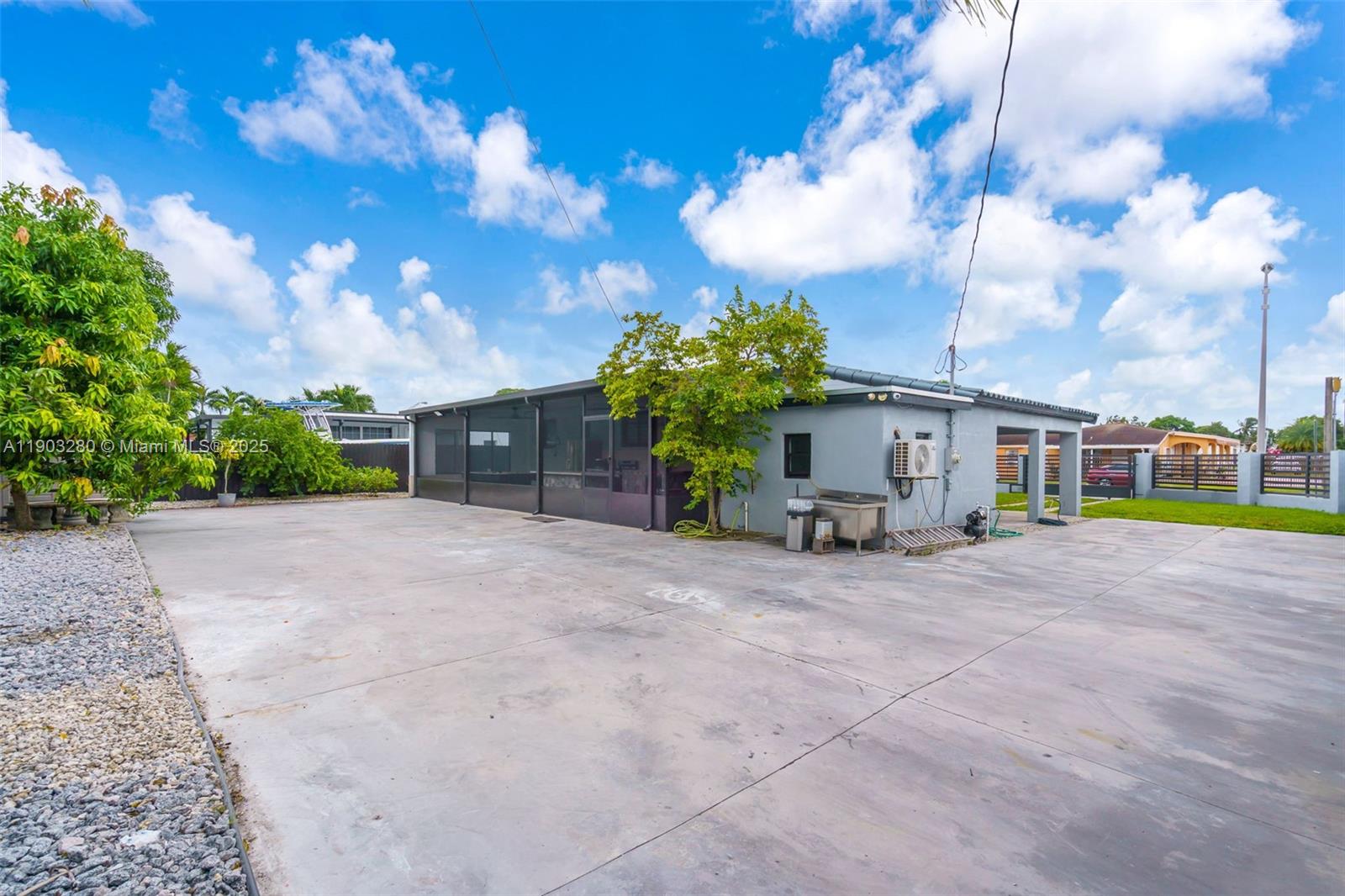 175 West 56th Street Hialeah, FL 33012 - Photo 30 of 39 a view of a house with a yard and garage