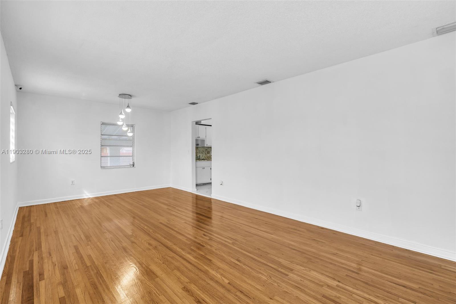 175 West 56th Street Hialeah, FL 33012 - Photo 4 of 39 a view of empty room with wooden floor