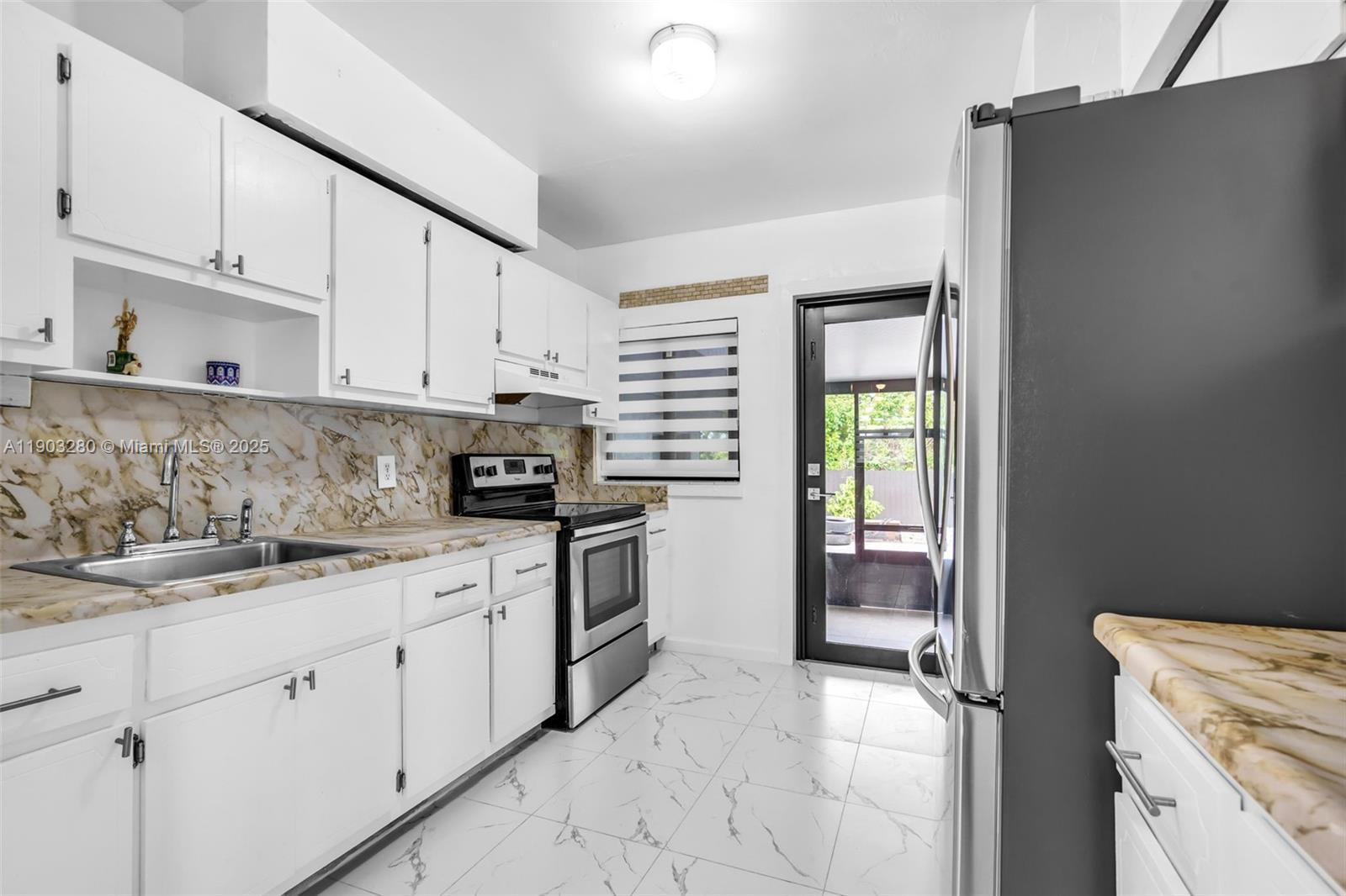 175 West 56th Street Hialeah, FL 33012 - Photo 8 of 39 a kitchen with a sink stove and cabinets