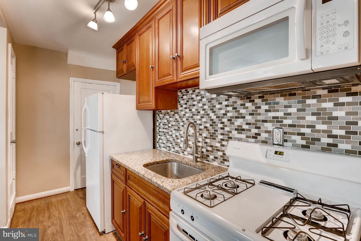 7530 Westfield Road Baltimore, MD 21222 - Photo 12 of 30 a kitchen with a sink a stove and refrigerator