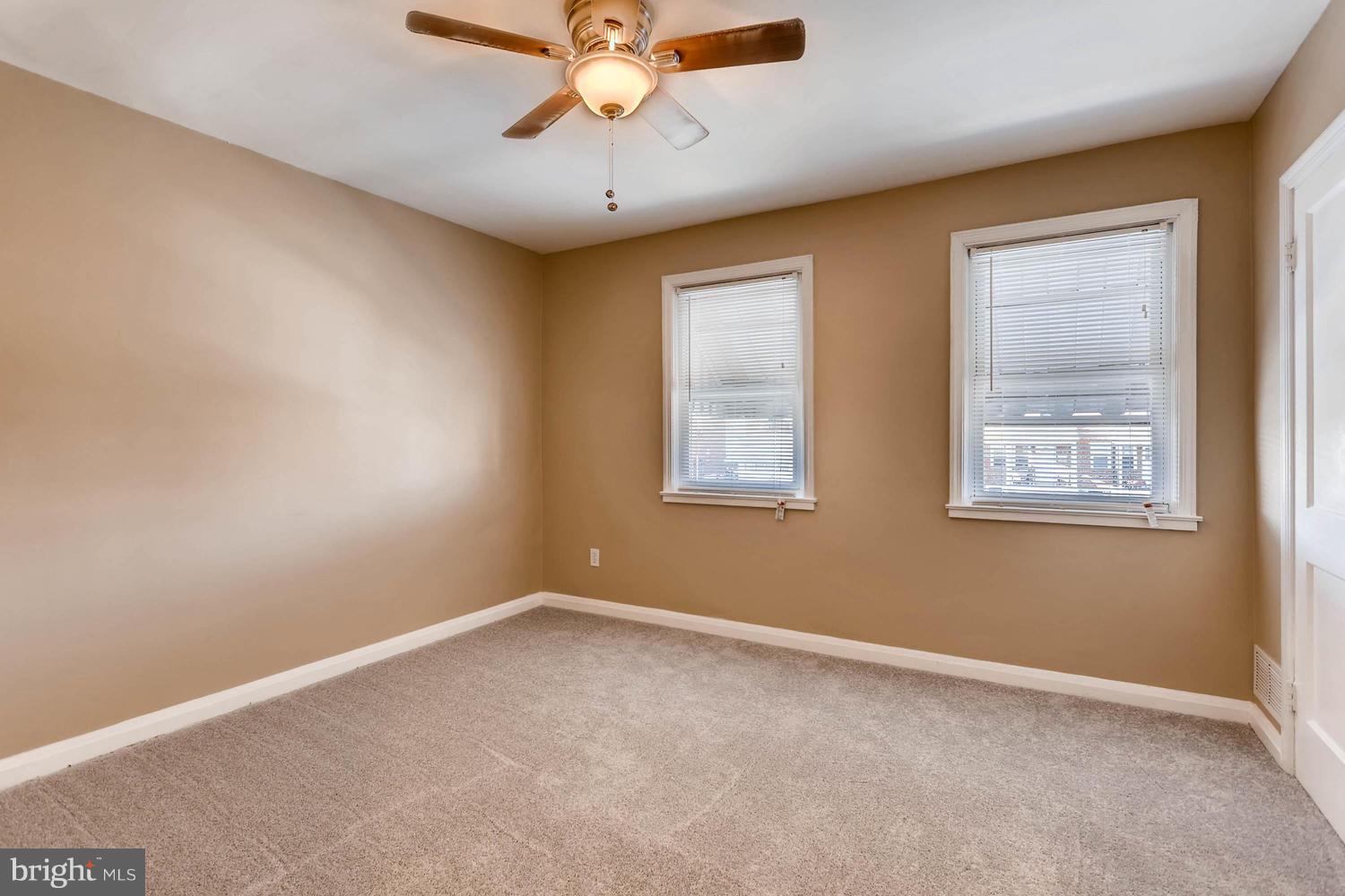 7530 Westfield Road Baltimore, MD 21222 - Photo 14 of 30 an empty room with a window and a fan