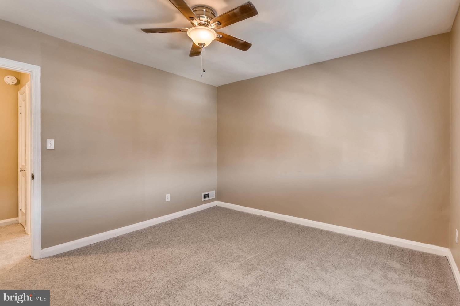 7530 Westfield Road Baltimore, MD 21222 - Photo 15 of 30 an empty room with a fan and a fan