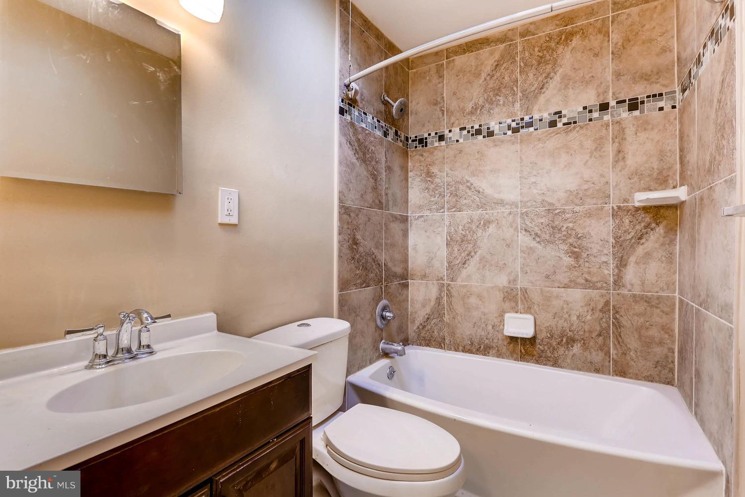 7530 Westfield Road Baltimore, MD 21222 - Photo 20 of 30 a bathroom with a sink toilet and shower