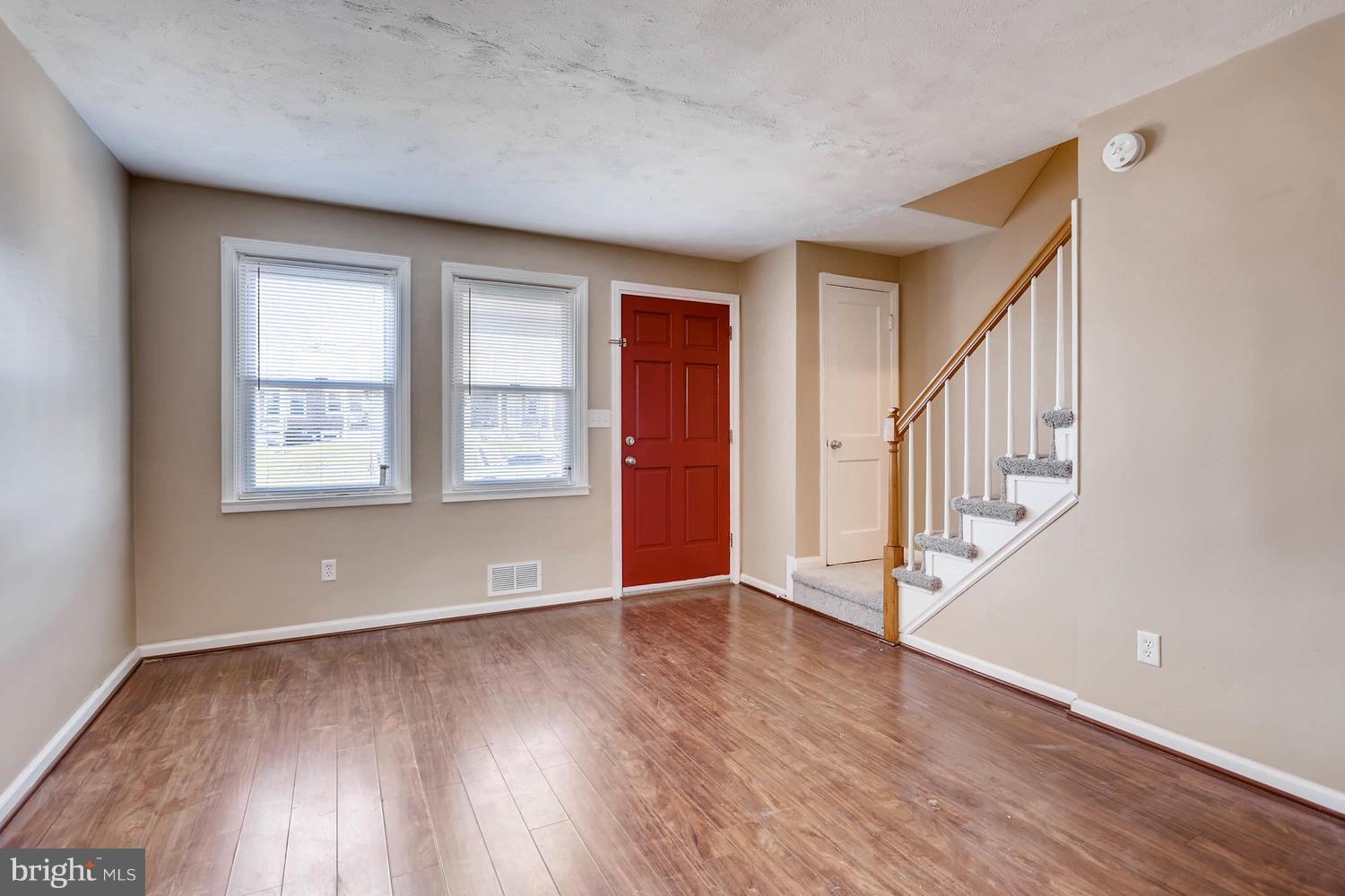 7530 Westfield Road Baltimore, MD 21222 - Photo 4 of 30 a view of an empty room with wooden floor and a window