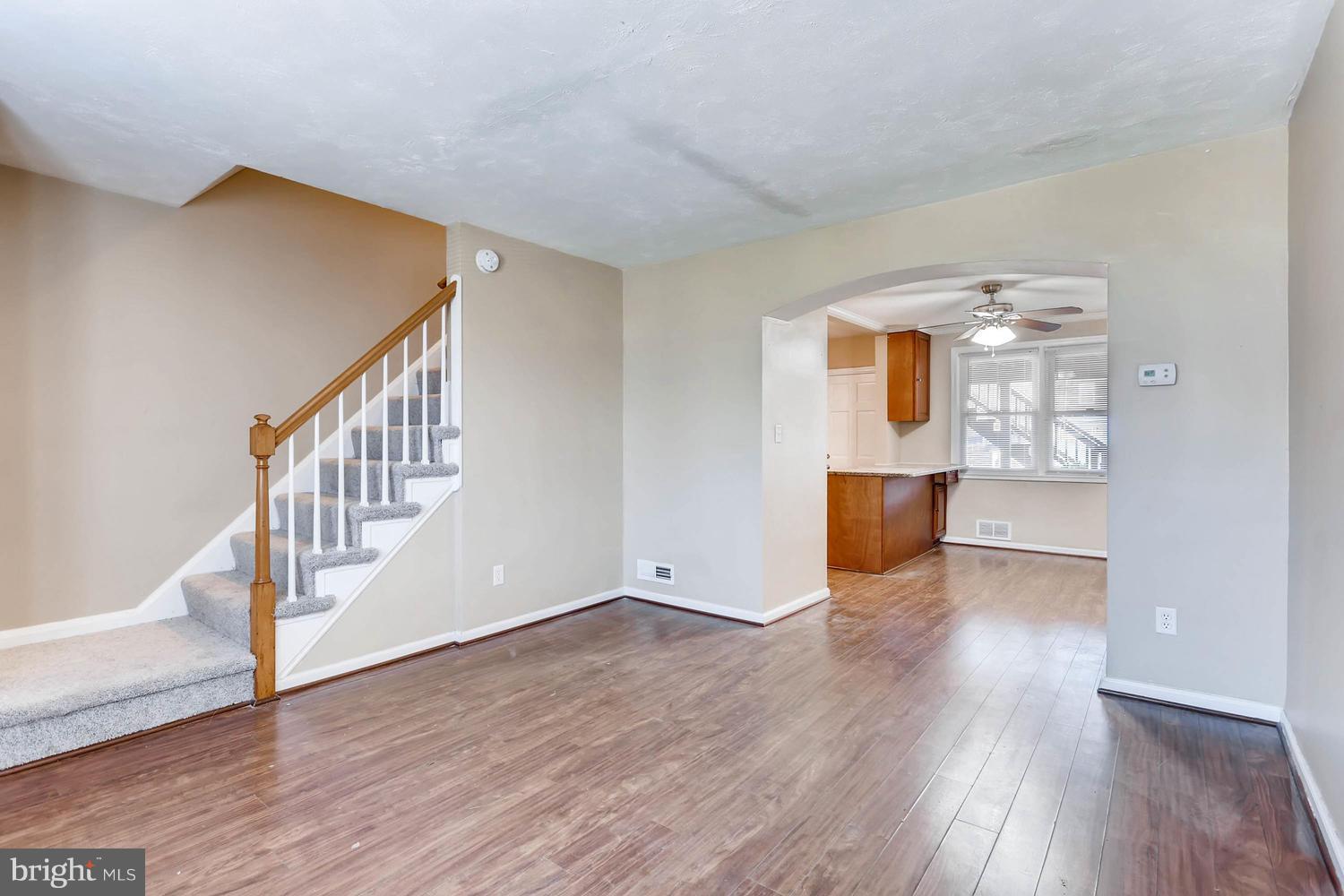 7530 Westfield Road Baltimore, MD 21222 - Photo 6 of 30 a view of an empty room with wooden floor and stairs