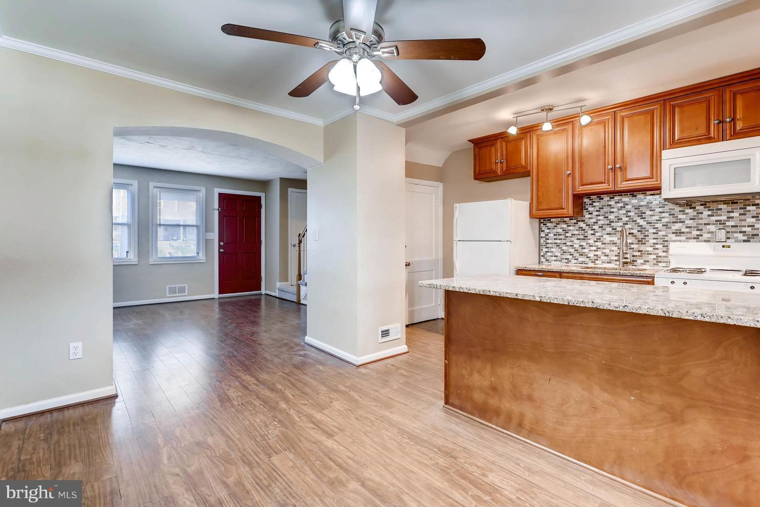 7530 Westfield Road Baltimore, MD 21222 - Photo 8 of 30 a view of a livingroom with wooden floor and a ceiling fan