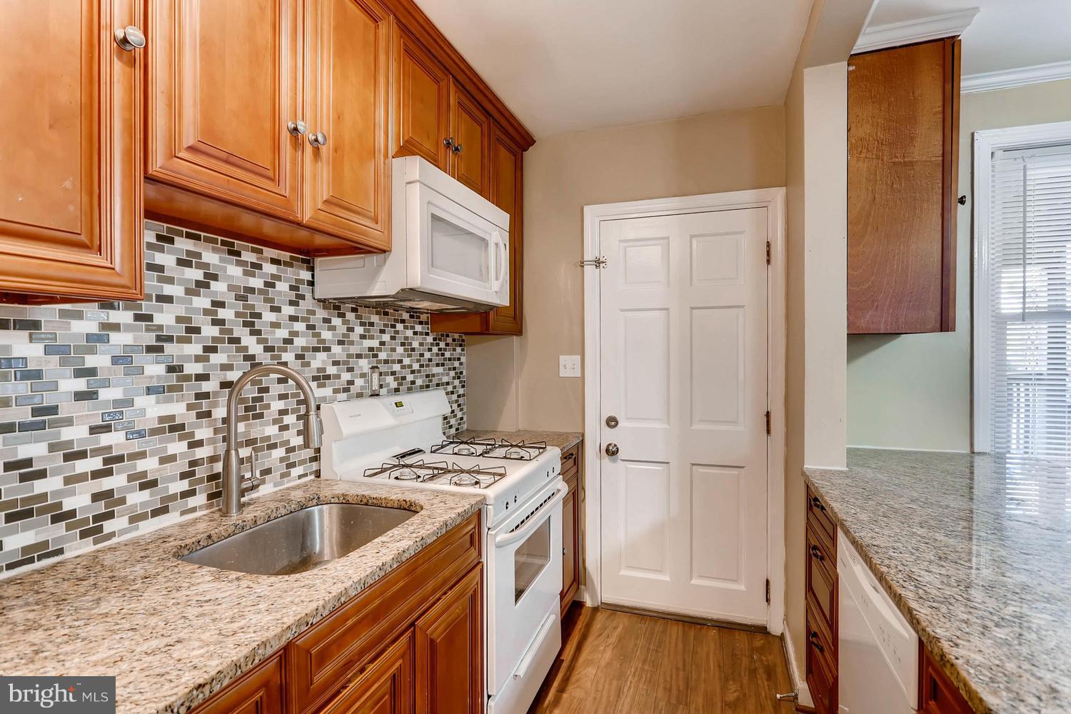 7530 Westfield Road Baltimore, MD 21222 - Photo 10 of 30 a kitchen with a sink stove and refrigerator