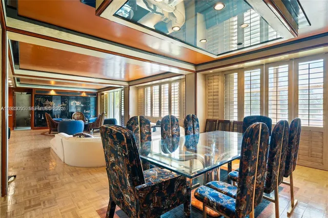 a view of a dining room with furniture large windows and wooden floor