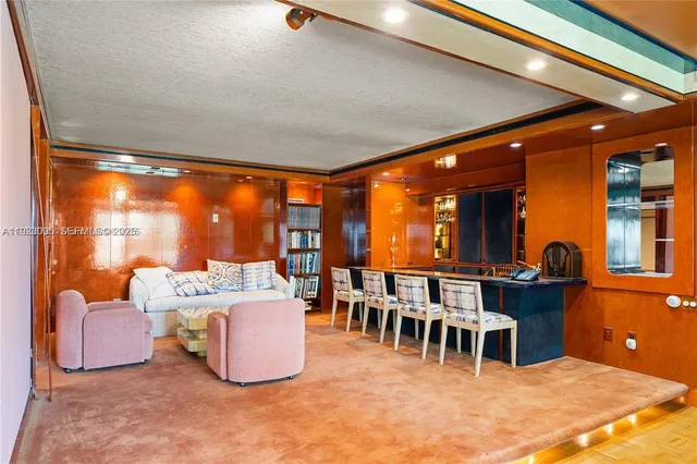 a dining room with furniture and a large window