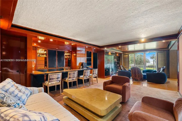 a living room with furniture and large windows