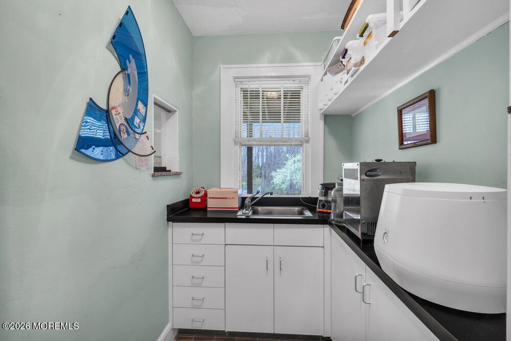 34 State Route Colts Neck, NJ 07722 - Photo 17 of 40 a kitchen with a sink and a refrigerator