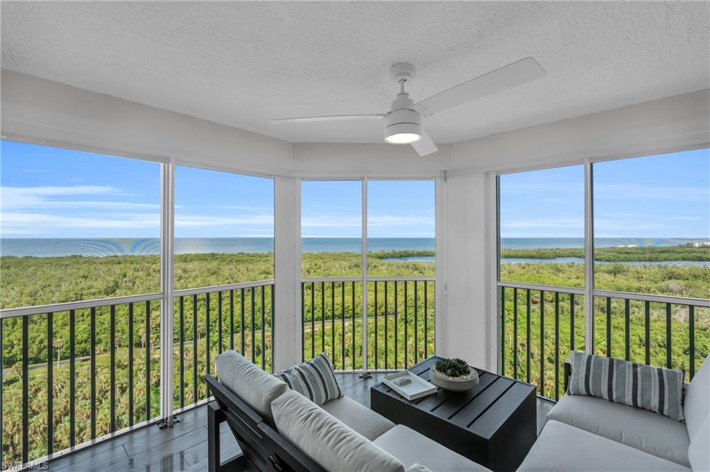 6573 Marissa Loop, Unit 1403 Naples, FL 34108 - Photo 1 of 29 a living room with furniture and a floor to ceiling window