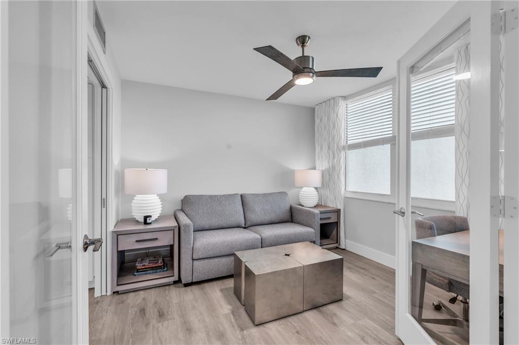 6573 Marissa Loop, Unit 1403 Naples, FL 34108 - Photo 12 of 29 a living room with furniture and a flat screen tv